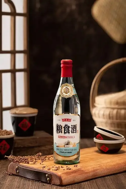 桌上摆着几瓶十几元的白酒和酿酒粮食，酿酒师分享平价粮食酒的选购心得_1