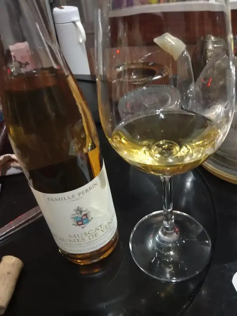 资深酿酒师在酒窖中讲解白葡萄酒知识，手持酒杯，表情亲切专业_1