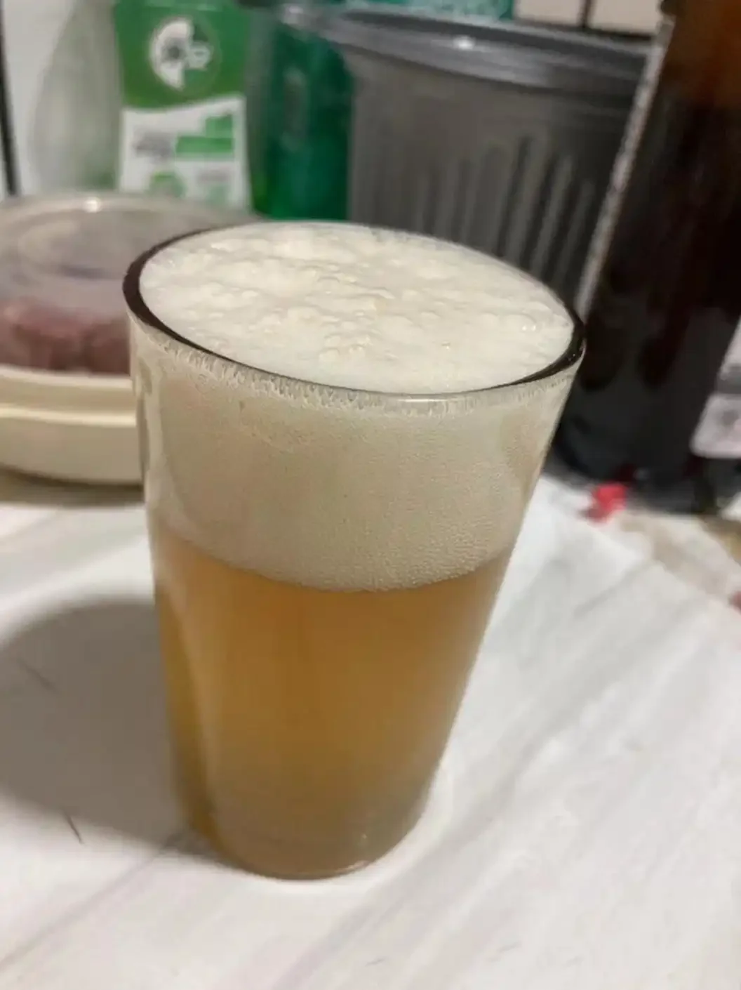 精酿啤酒与工业啤酒的视觉对比图，展示两者在标签设计、酒体颜色和泡沫状态上的明显差异_1