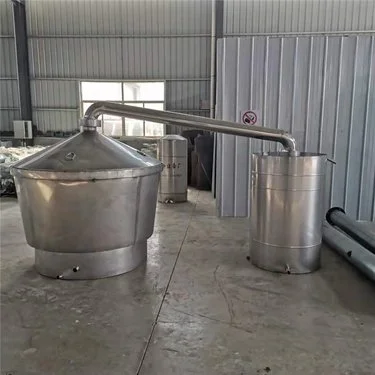 小型酿酒坊内，不锈钢白酒蒸馏设备正在出酒，酒液清澈透明。_1